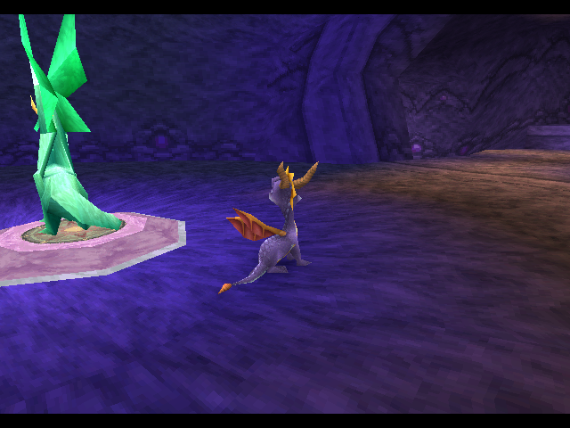 Spyro standing next to Boldar's Dragon Statue